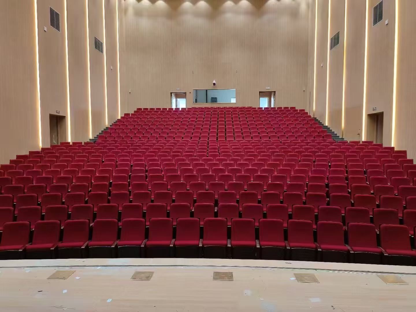 Auditorium chair row installation in lecture hall by STARROAD SEATING